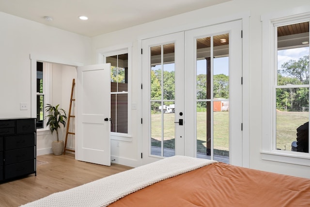 bedroom with access to exterior, recessed lighting, baseboards, and wood finished floors