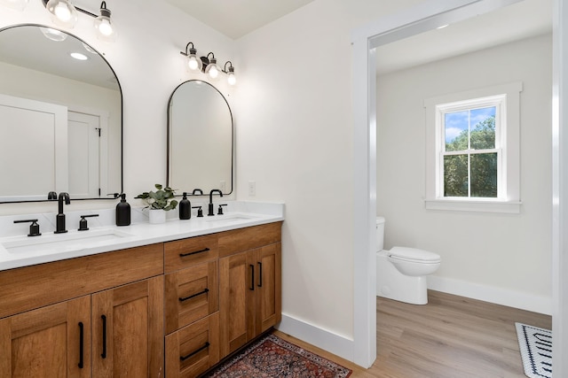 bathroom featuring baseboards, visible vents, a sink, and toilet