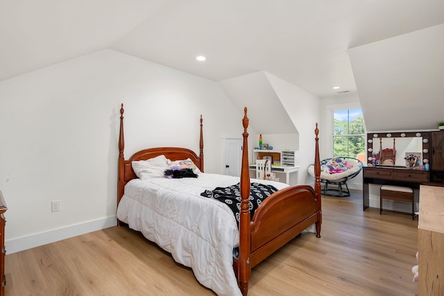 bedroom with light wood-style floors, lofted ceiling, baseboards, and recessed lighting