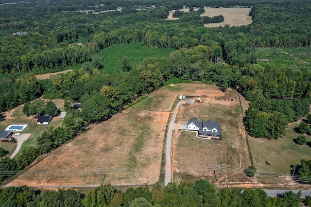 drone / aerial view with a wooded view