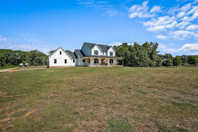 view of front facade with a porch, a front lawn, and board and batten siding