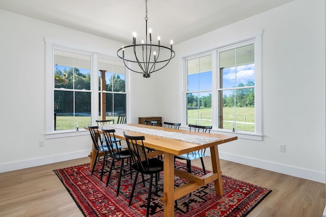 dining area featuring baseboards, plenty of natural light, and light wood finished floors