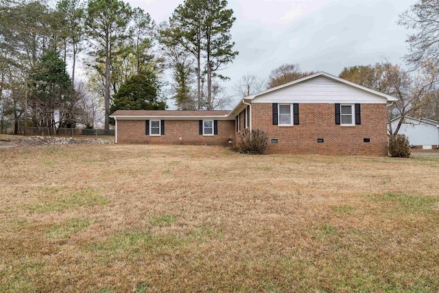 exterior space with brick siding, crawl space, and a front yard