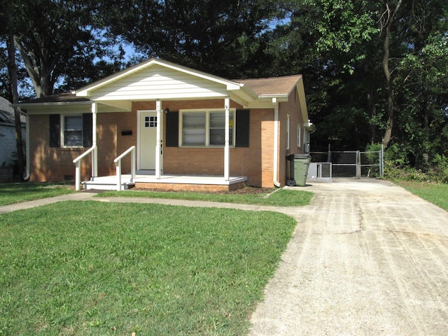 bungalow-style house with central air condition unit, a porch, and a front yard