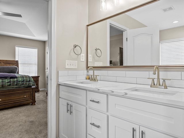 bathroom with vanity and decorative backsplash