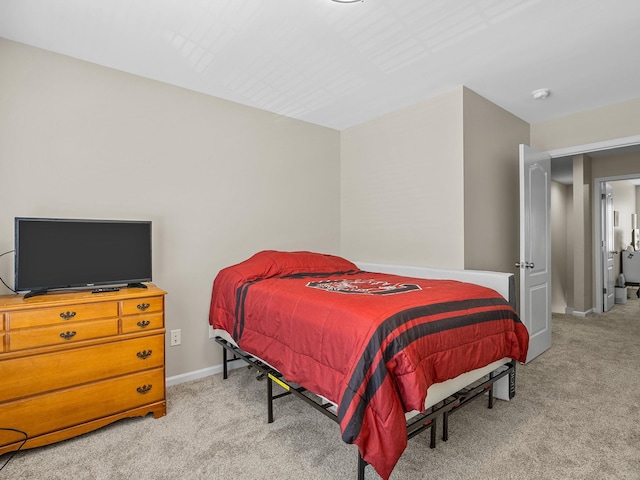 bedroom featuring light carpet