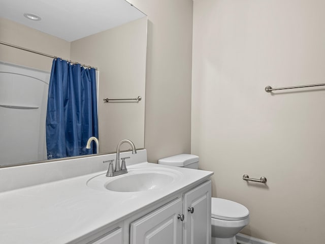 bathroom featuring vanity, toilet, and a shower with shower curtain