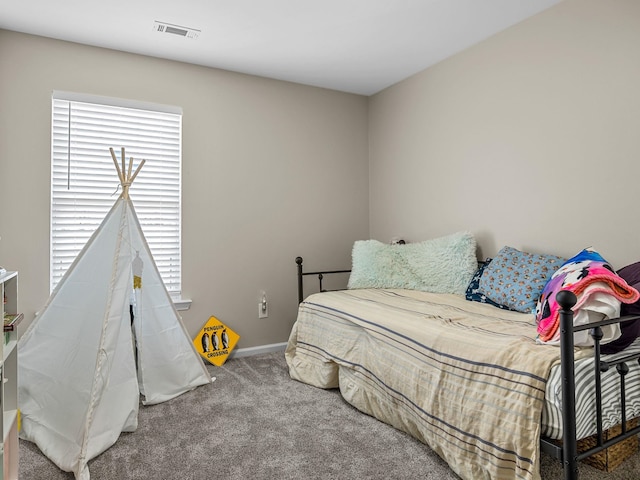 bedroom with carpet and multiple windows