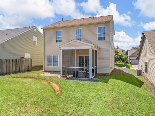 back of property featuring central AC unit, a sunroom, and a lawn