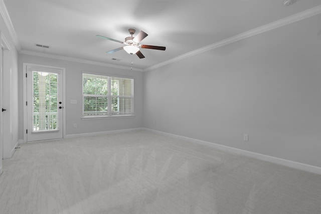 unfurnished room with light carpet, visible vents, baseboards, a ceiling fan, and crown molding