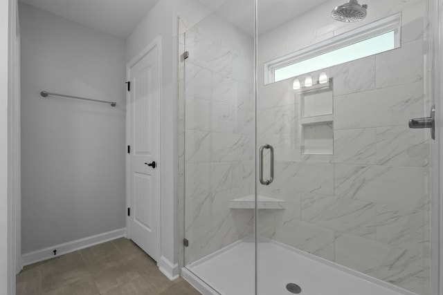 full bath featuring a stall shower and baseboards