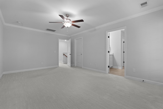 empty room featuring a ceiling fan, baseboards, visible vents, and crown molding