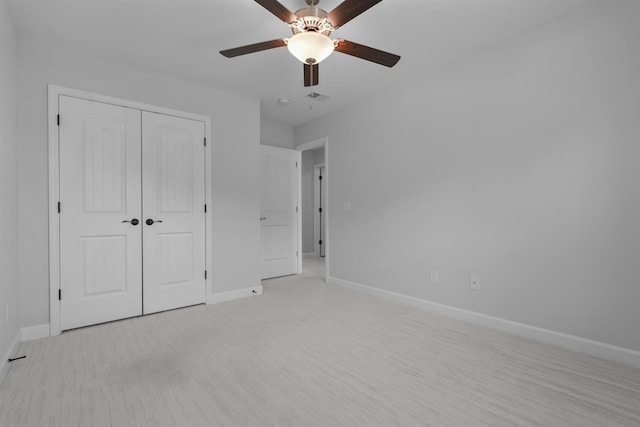 unfurnished bedroom featuring visible vents, baseboards, ceiling fan, and a closet