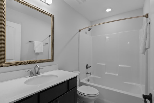 bathroom with tub / shower combination, vanity, and toilet