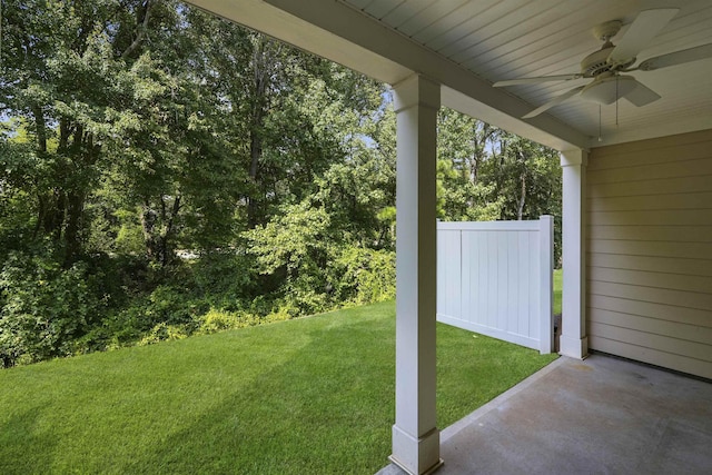 view of yard featuring a ceiling fan and fence