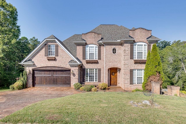 view of front of home featuring a garage and a front yard