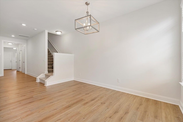 interior space featuring an inviting chandelier and light wood-type flooring