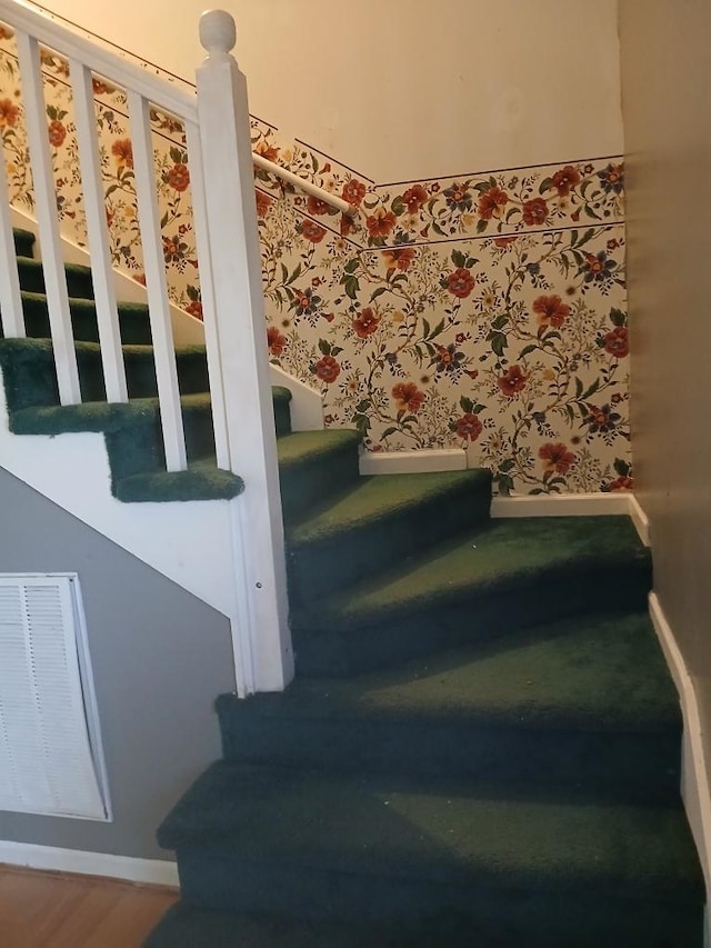 stairs featuring hardwood / wood-style flooring