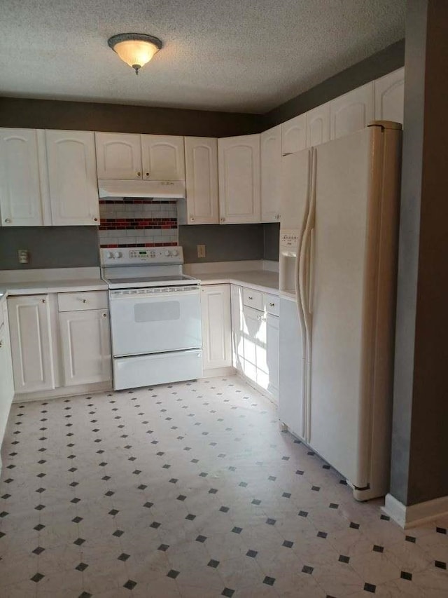 kitchen featuring a textured ceiling, white appliances, and white cabinetry