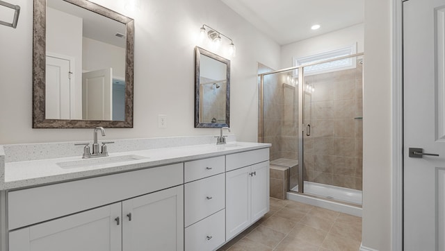 bathroom featuring vanity, tile patterned floors, and a shower with door