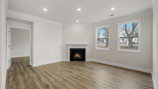 unfurnished living room featuring ornamental molding and hardwood / wood-style floors