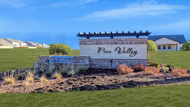 community / neighborhood sign with a lawn