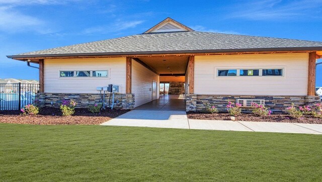 exterior space with a carport and a front yard