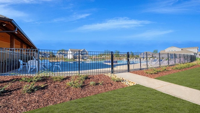 view of swimming pool featuring a lawn