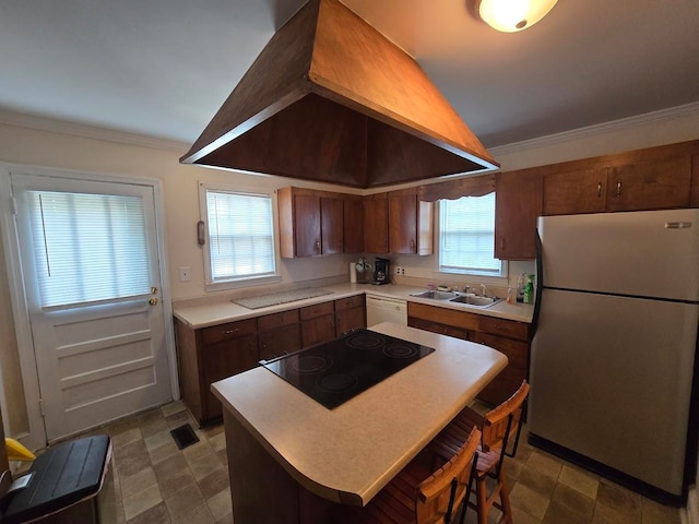 kitchen with stainless steel fridge, ornamental molding, black electric stovetop, sink, and custom exhaust hood