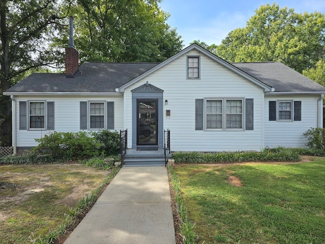 single story home featuring a front lawn