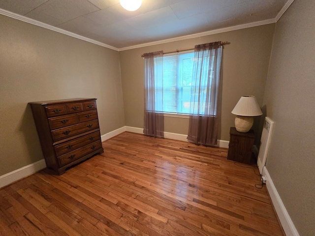 bedroom featuring crown molding and wood-type flooring