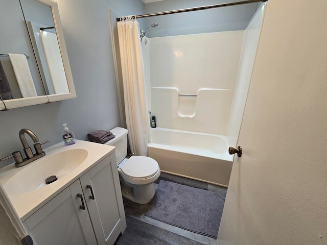 full bathroom featuring vanity, toilet, hardwood / wood-style floors, and shower / bath combo with shower curtain