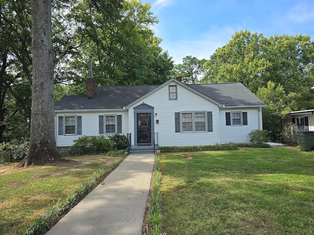 single story home featuring a front lawn