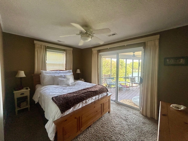 bedroom featuring a textured ceiling, access to exterior, ceiling fan, and multiple windows