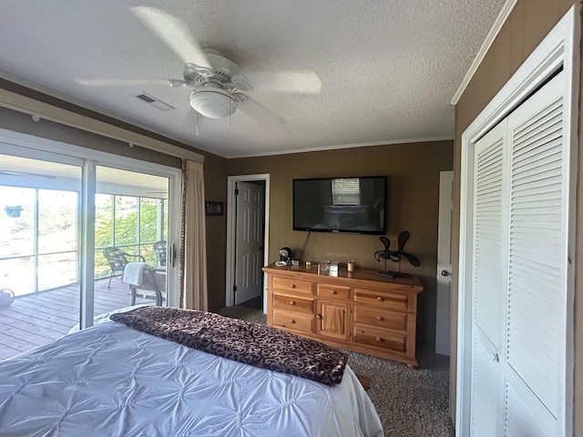 carpeted bedroom with ornamental molding, a textured ceiling, access to exterior, ceiling fan, and a closet