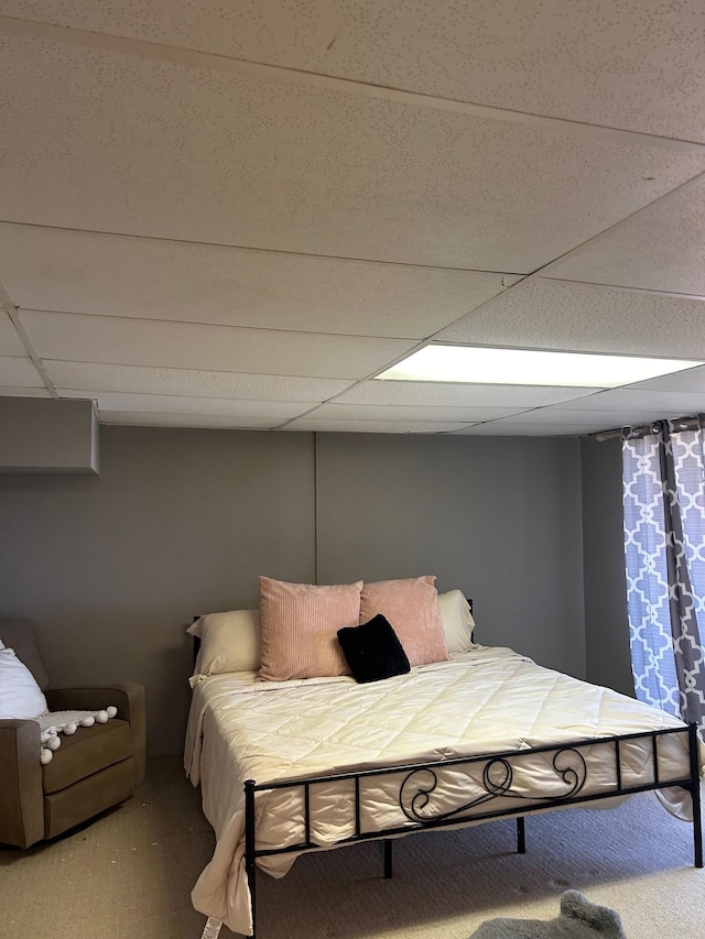 bedroom with a paneled ceiling and carpet floors