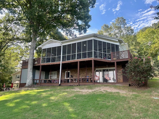 rear view of property featuring a yard and a sunroom