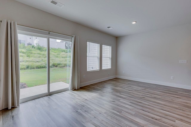 spare room with light wood-type flooring