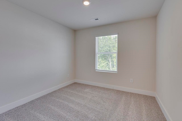 spare room with light colored carpet