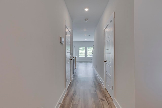 hallway with light hardwood / wood-style flooring