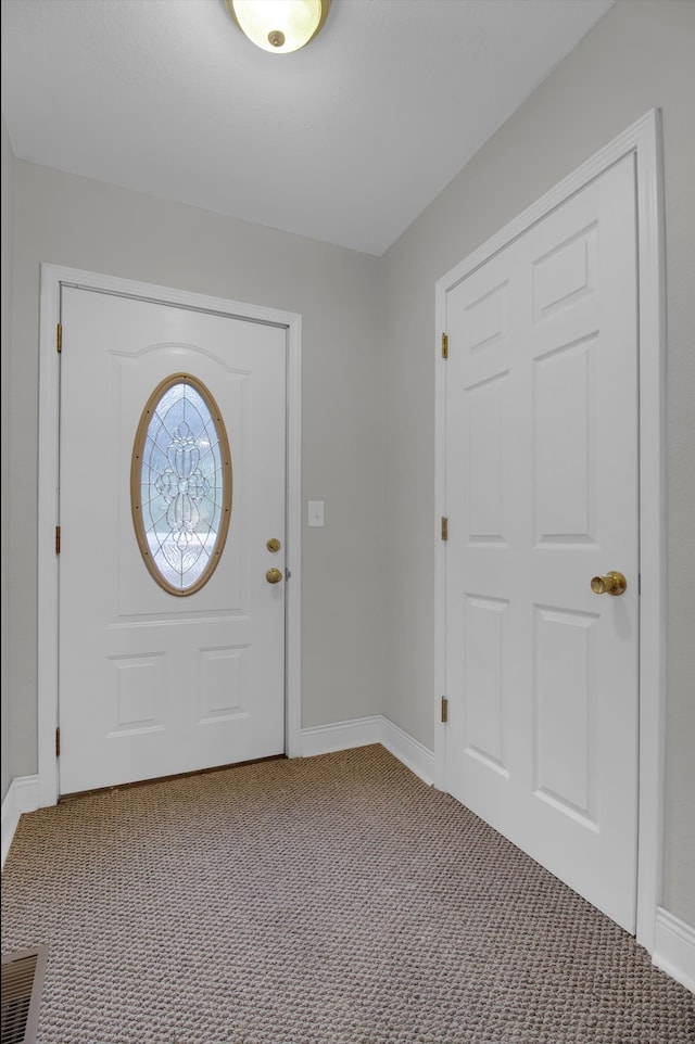 view of carpeted foyer entrance