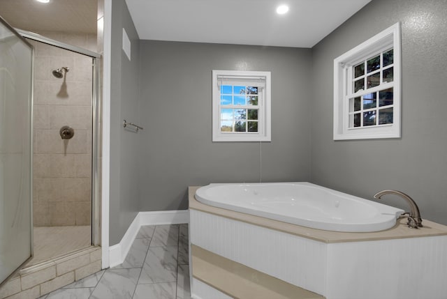 bathroom featuring separate shower and tub