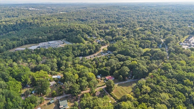 bird's eye view with a wooded view