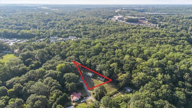 birds eye view of property with a view of trees