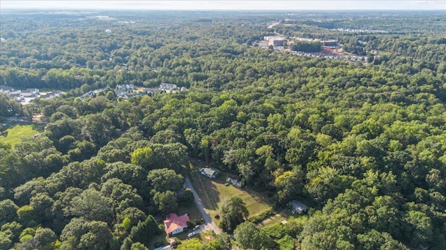 drone / aerial view featuring a wooded view