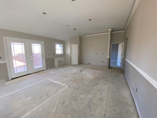 unfurnished living room with vaulted ceiling, french doors, and ornamental molding