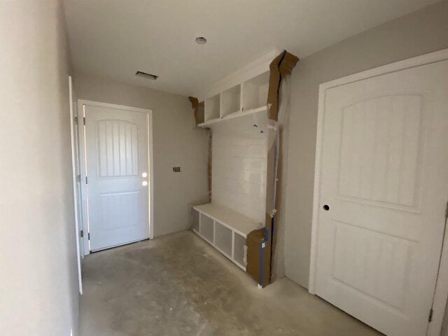 mudroom with visible vents and unfinished concrete floors