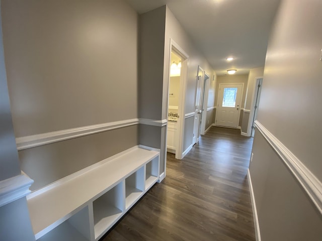 hall featuring dark wood-style floors and baseboards