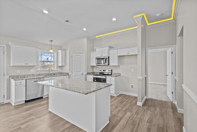 kitchen with visible vents, light wood-style flooring, appliances with stainless steel finishes, white cabinetry, and a sink