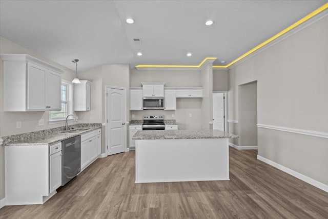 kitchen with white cabinetry, appliances with stainless steel finishes, a sink, and wood finished floors